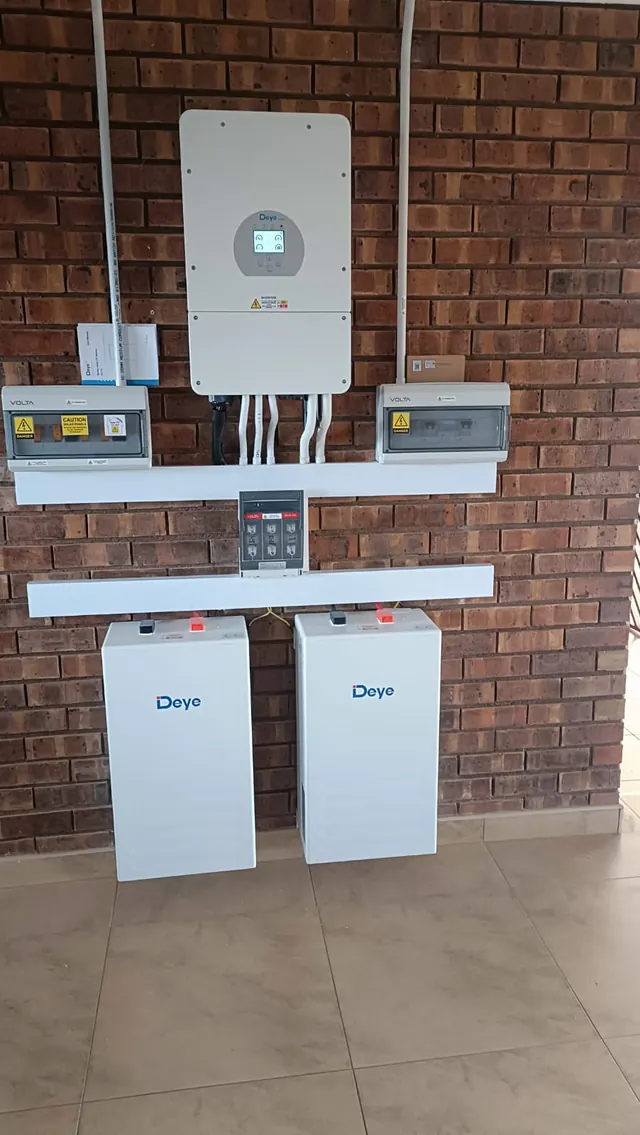 Residential Installation: A Deye inverter with Volta enclosures and twin battery units installed on an exposed brick feature wall.