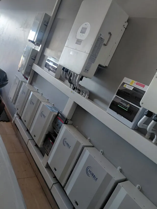 Residential Installation: A Deye hybrid inverter with Hubble battery storage and a Maxsolair-branded distribution board, installed on an interior wall.